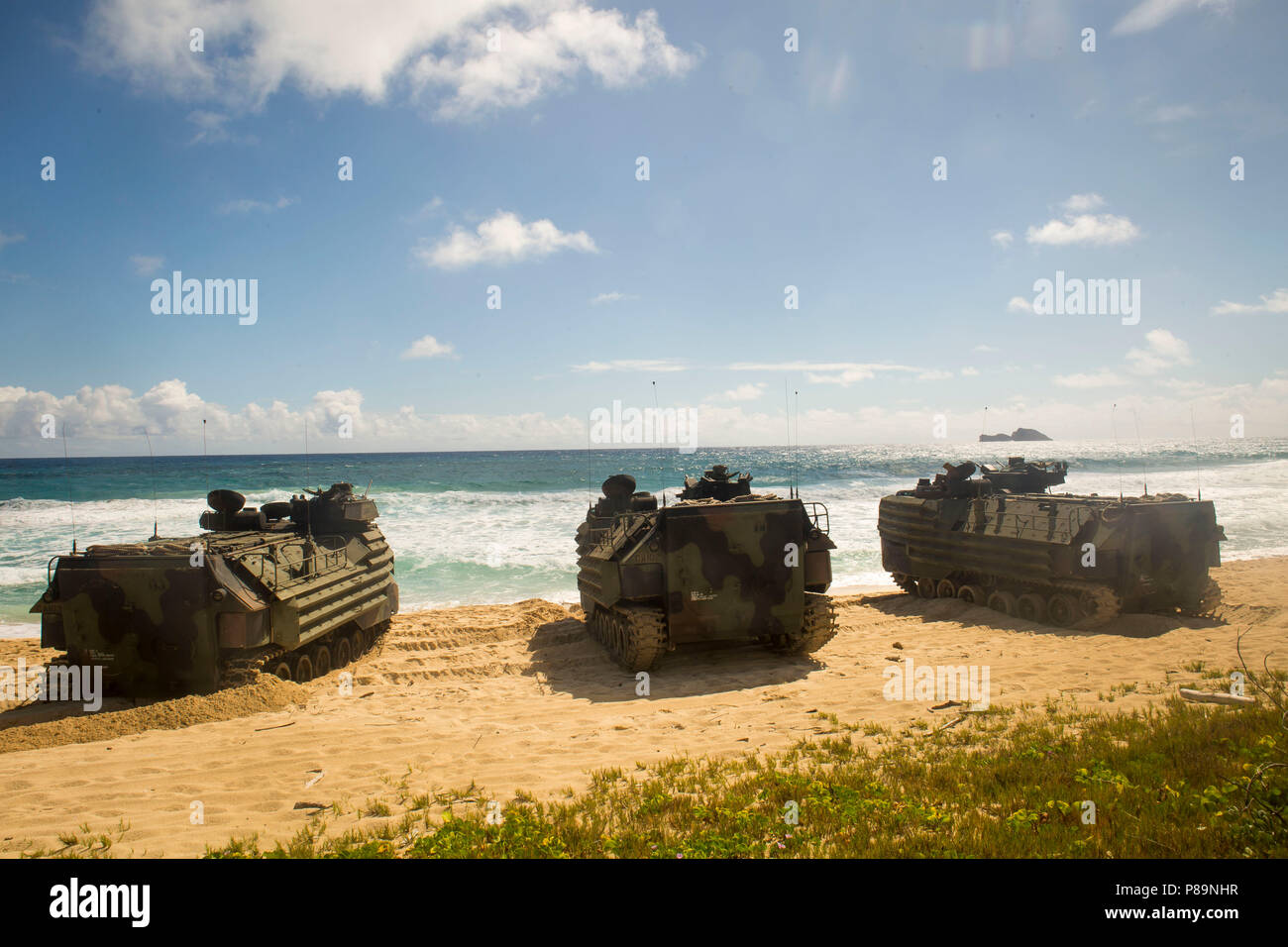 180708-M-ZO893-1004 MARINE CORPS BASE HAWAII (July 8, 2018) U.S. Marines with Combat Assault Company, 3rd Marine Regiment, in AAV-P7/A1 assault amphibious vehicles are staged in formation prior to splash training at Pyramid Rock Beach as part of Rim of the Pacific (RIMPAC) exercise on Marine Corps Base Hawaii July 8, 2018. RIMPAC provides high-value training for task-organized, highly capable Marine-Air Ground Task Force and enhances the critical crisis response capability of U.S. Marines in the Pacific. Twenty-five nations, 46 ships, five submarines, about 200 aircraft, and 25,000 personnel a Stock Photo