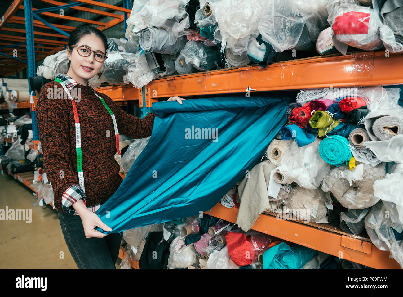 Asian female intern pulled out the clothes material and turned her body take a photo. Stock Photo