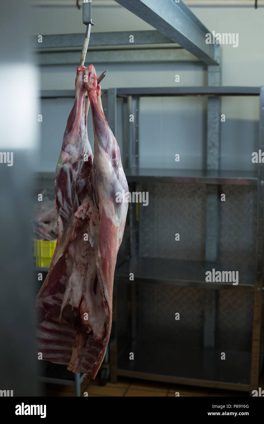Meat hanging in butcher shop Stock Photo
