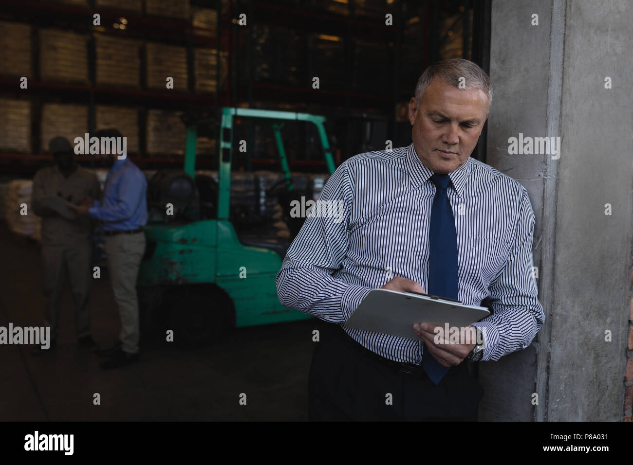Male manager writing on a clipboard Stock Photo