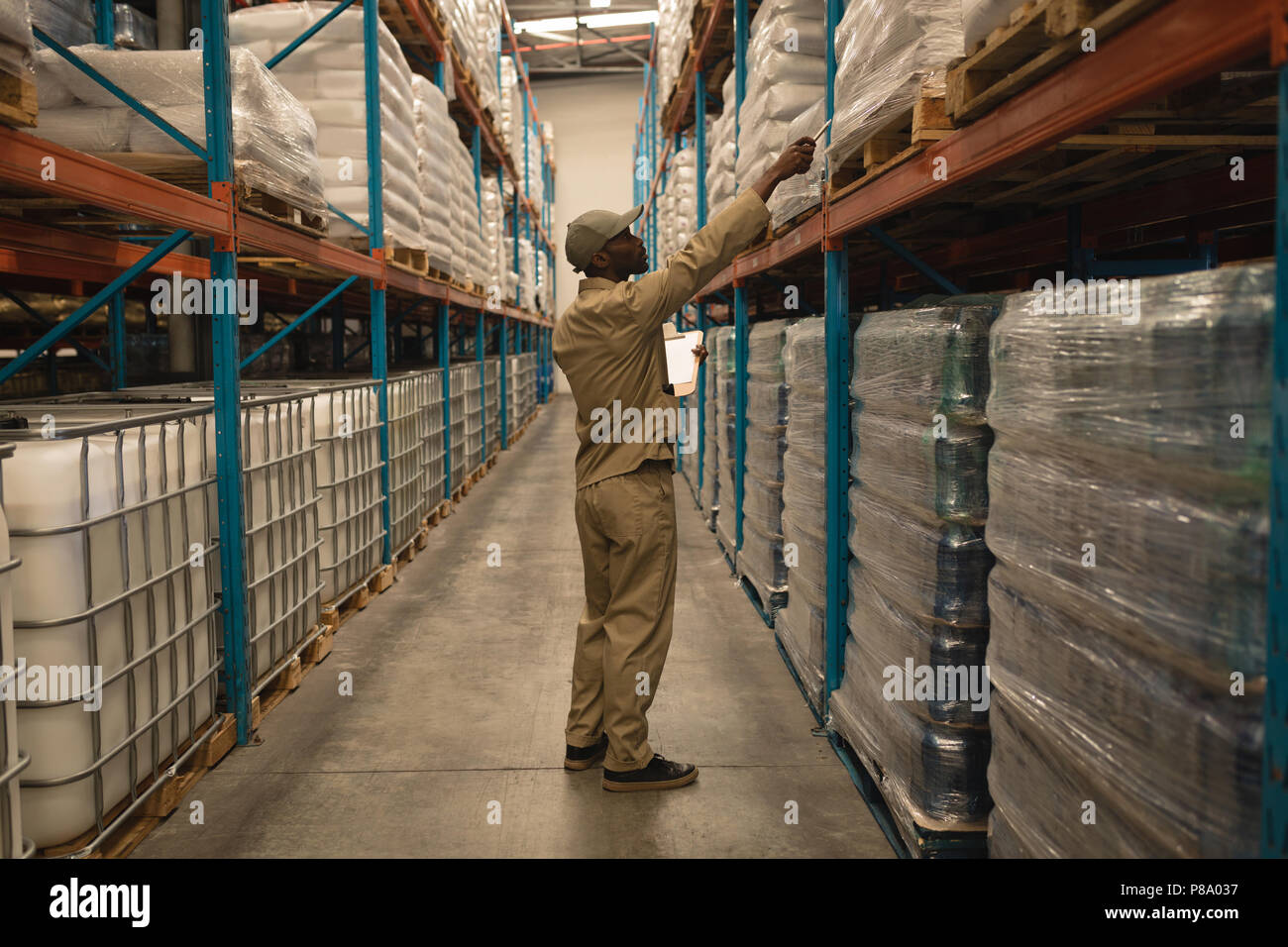 Worker checking stocks in warehouse Stock Photo