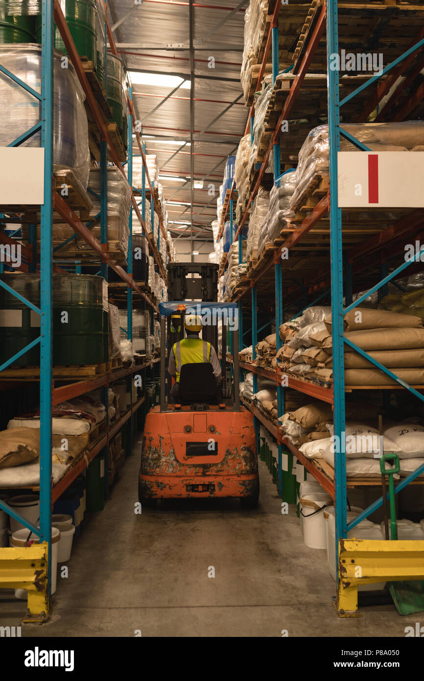 Male worker driving forklift Stock Photo