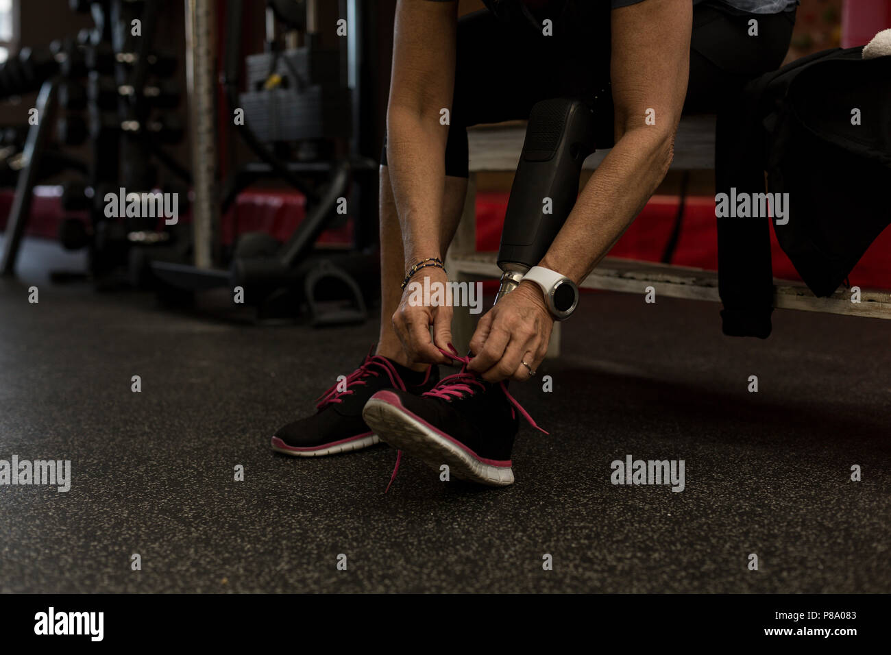 Photo inspiration: Visual Reference: Disabled Woman Tying Shoelaces In Gym Stock Photo