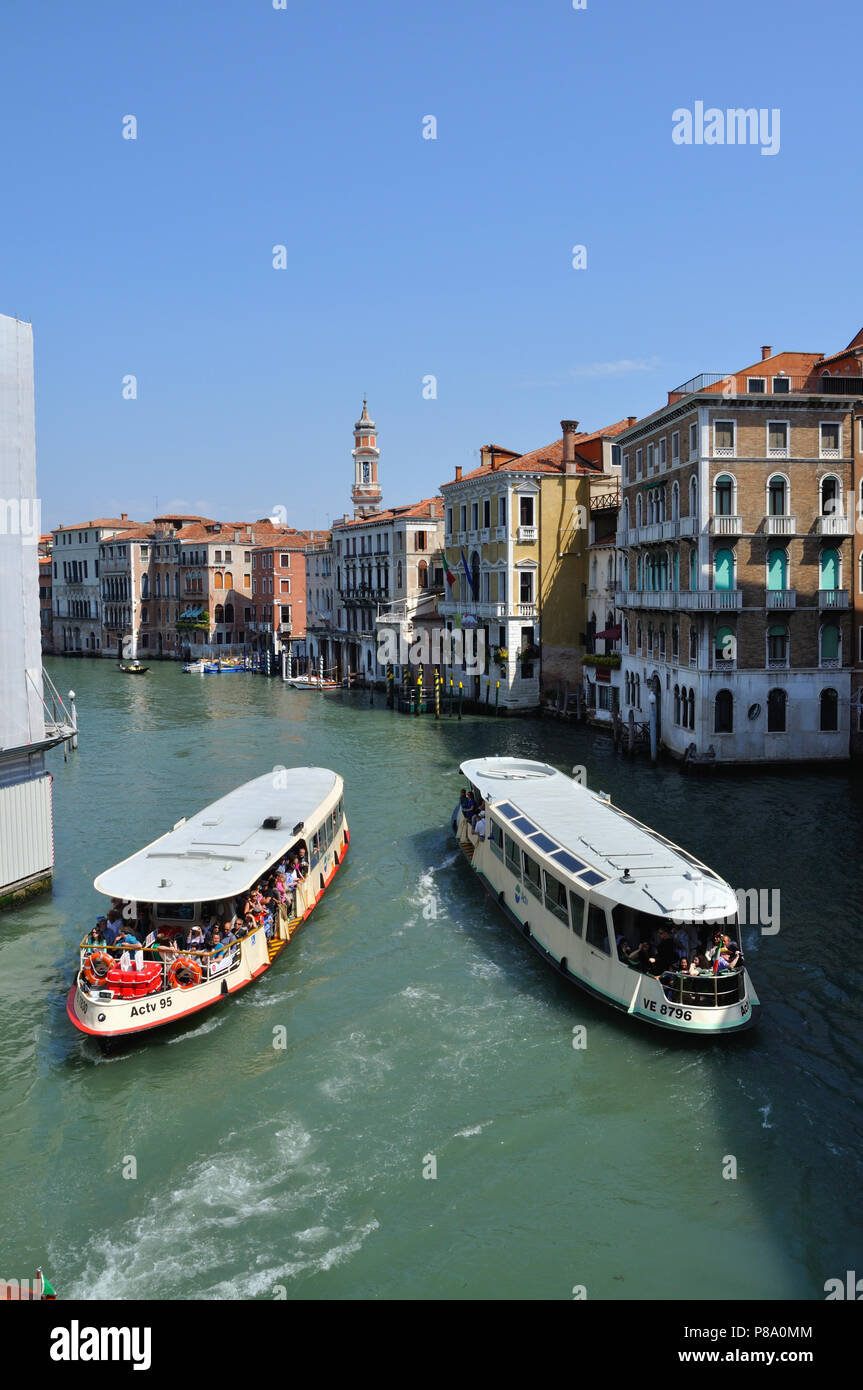 Water buses, or vaporetti, passing on the Grand Canal in Venice Stock Photo