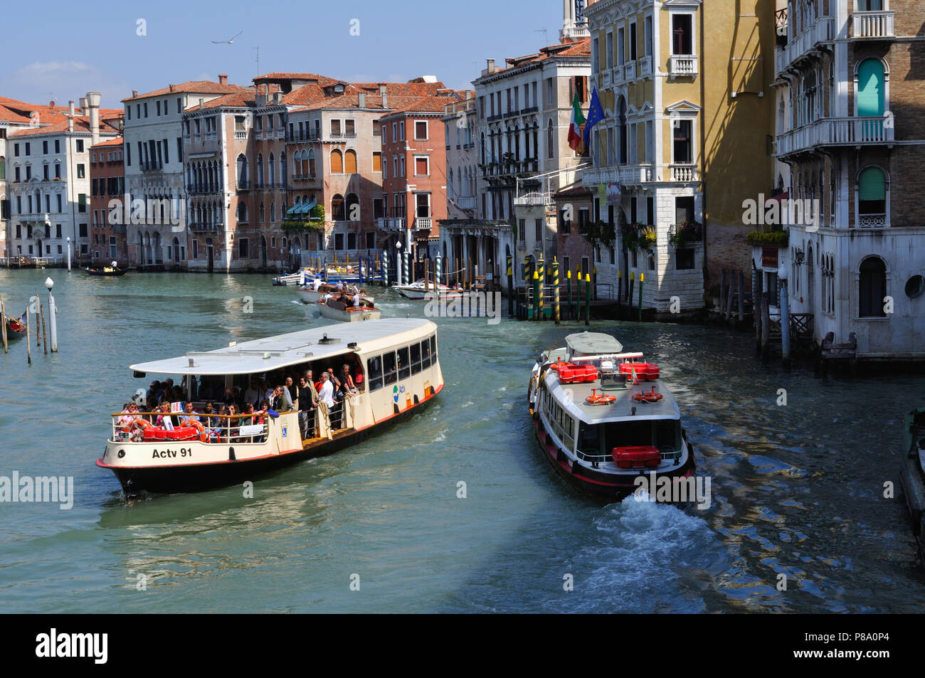 Water buses, or vaporetti, passing on the Grand Canal in Venice Stock Photo