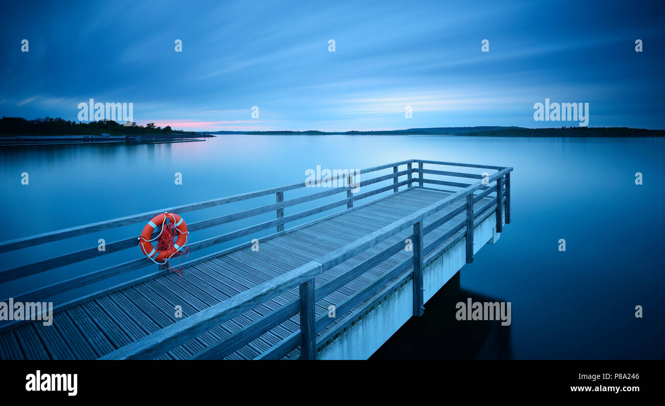 Pier in the harbour with life belt, dusk, lake Geiseltalsee, Braunsbedra, Saxony-Anhalt, Germany Stock Photo