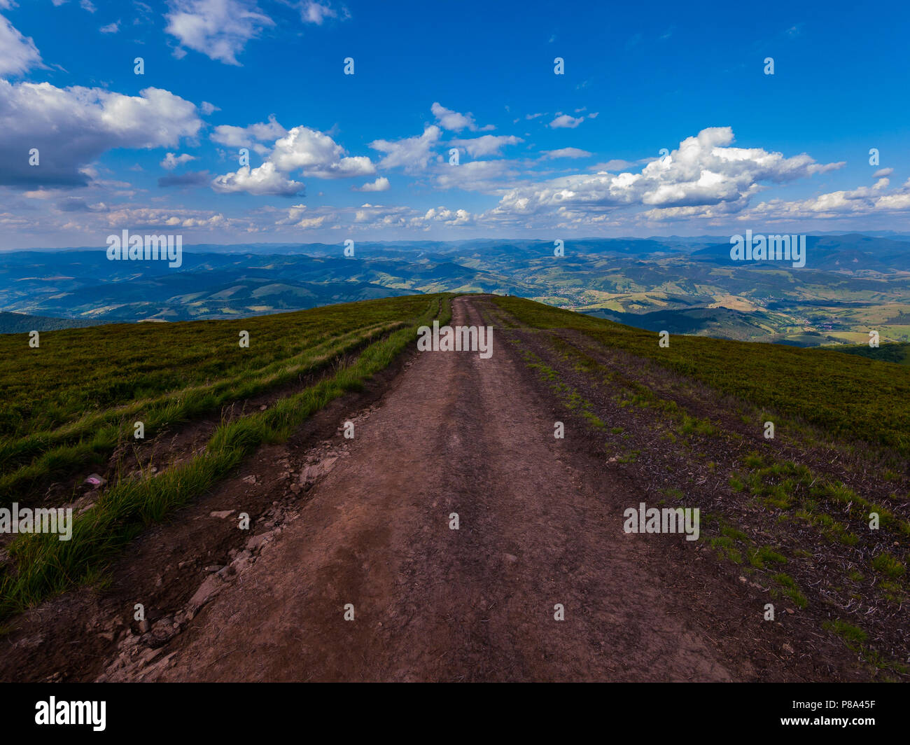 tropped mountain road leading down to the plain. A good place to go through the tourist routes . For your design Stock Photo