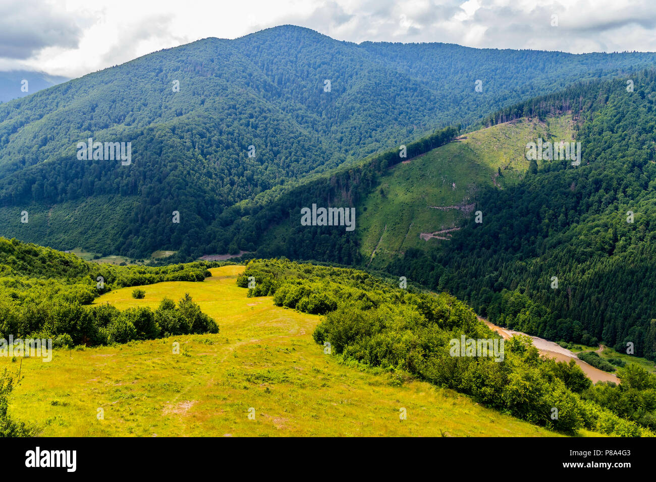 beautiful landscape on the Carpathian mountains with a river in the valley over which the shadows of clouds . For your design Stock Photo