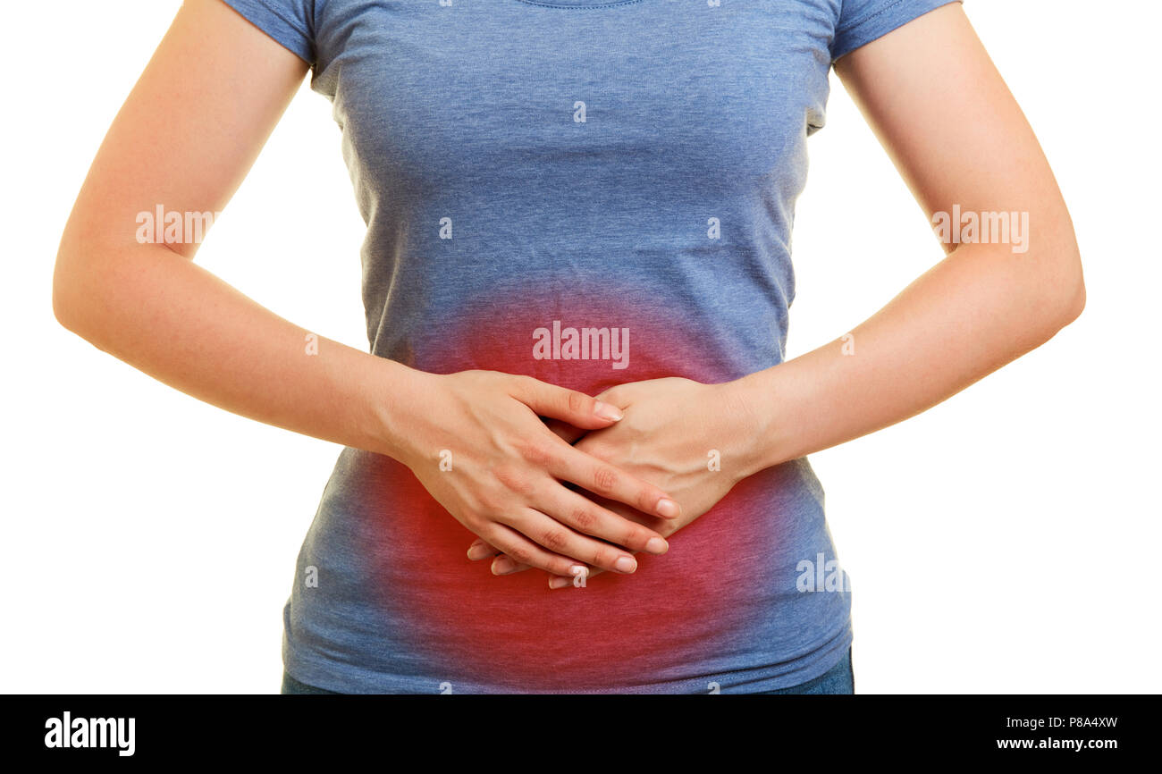 Young woman has pain and cramps or bloating in the abdomen Stock Photo