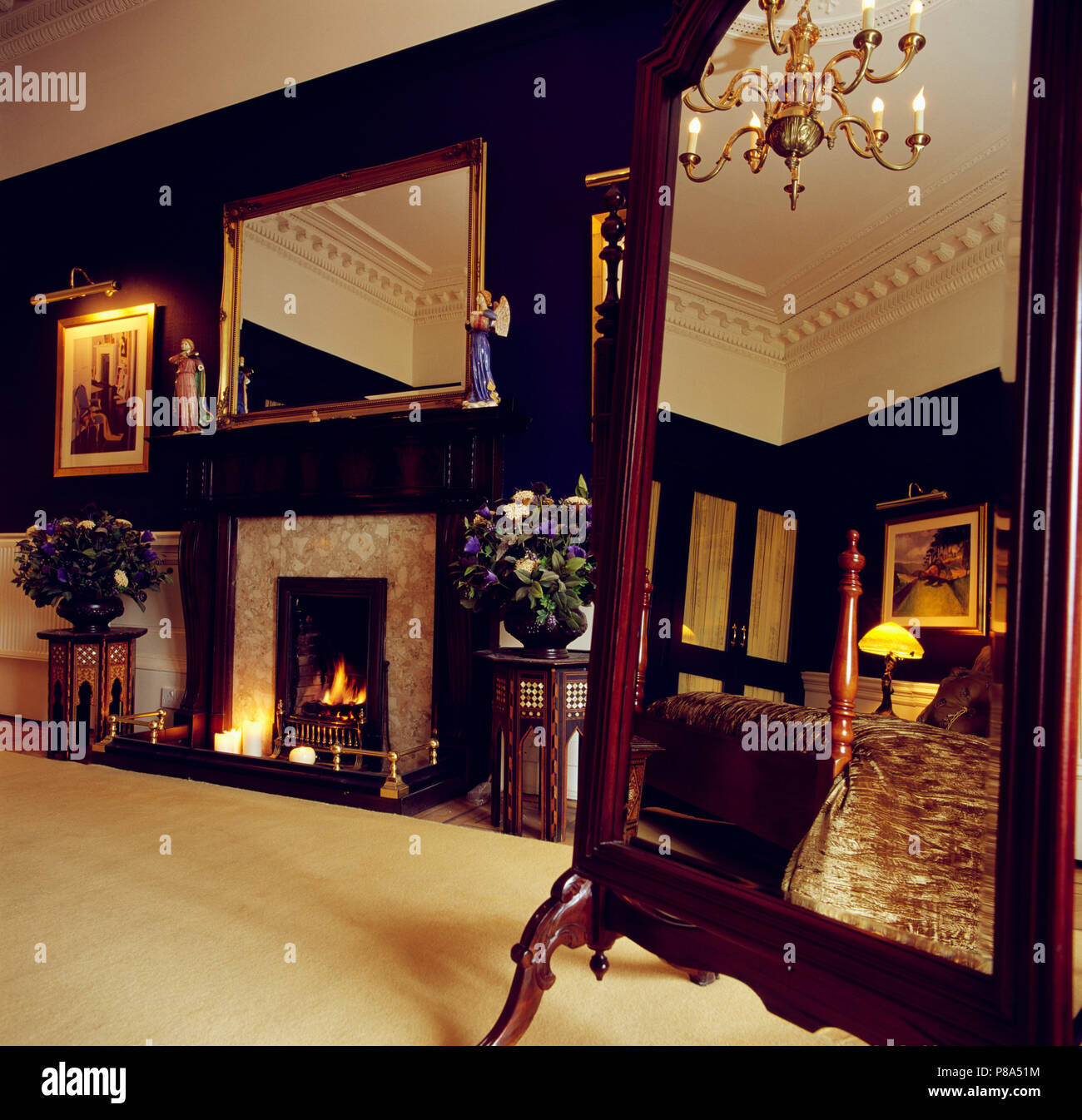 Cream carpet and cheval mirror in black bedroom with large gilt mirror ...