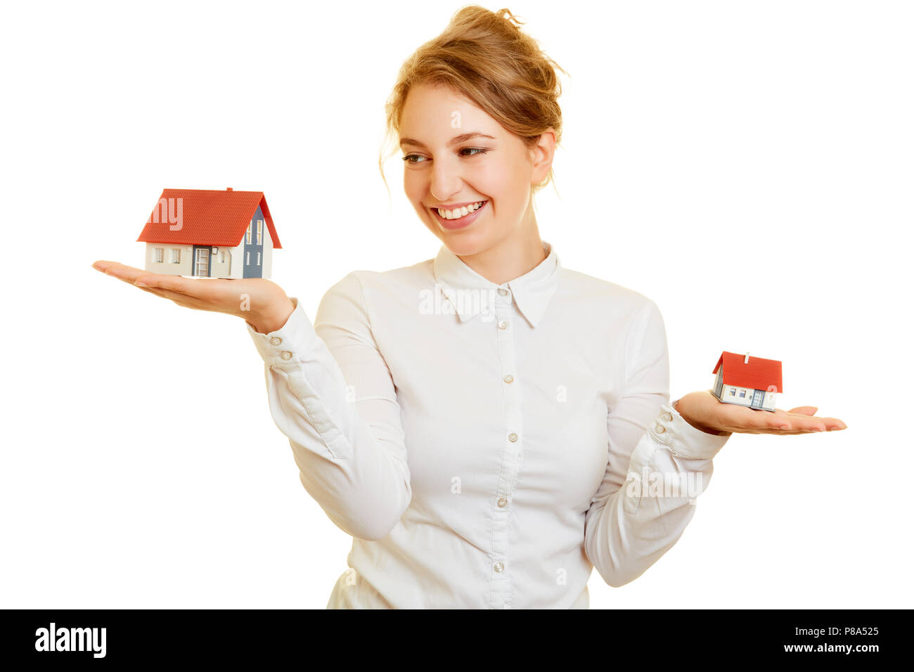 Young woman at real estate and houses compare on her palm Stock Photo