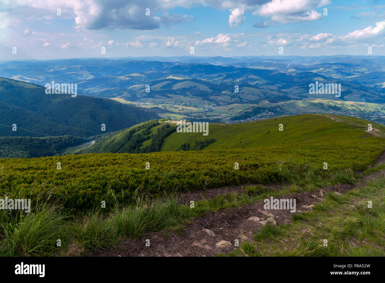 Mountain road leading to the descent of a high hill against the blue