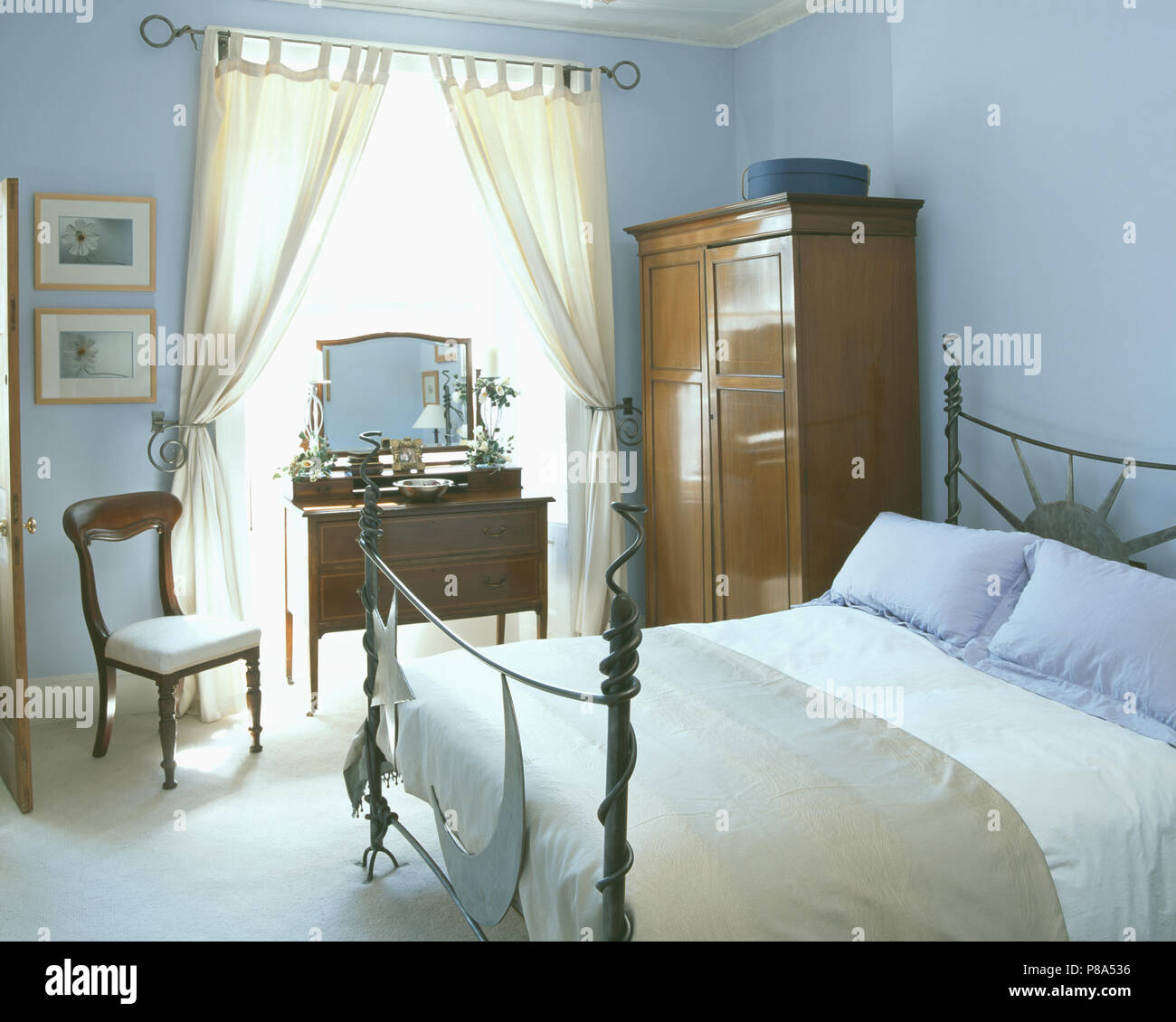 Modern Metal Bed With Blue And Cream Linen In Pastel Blue