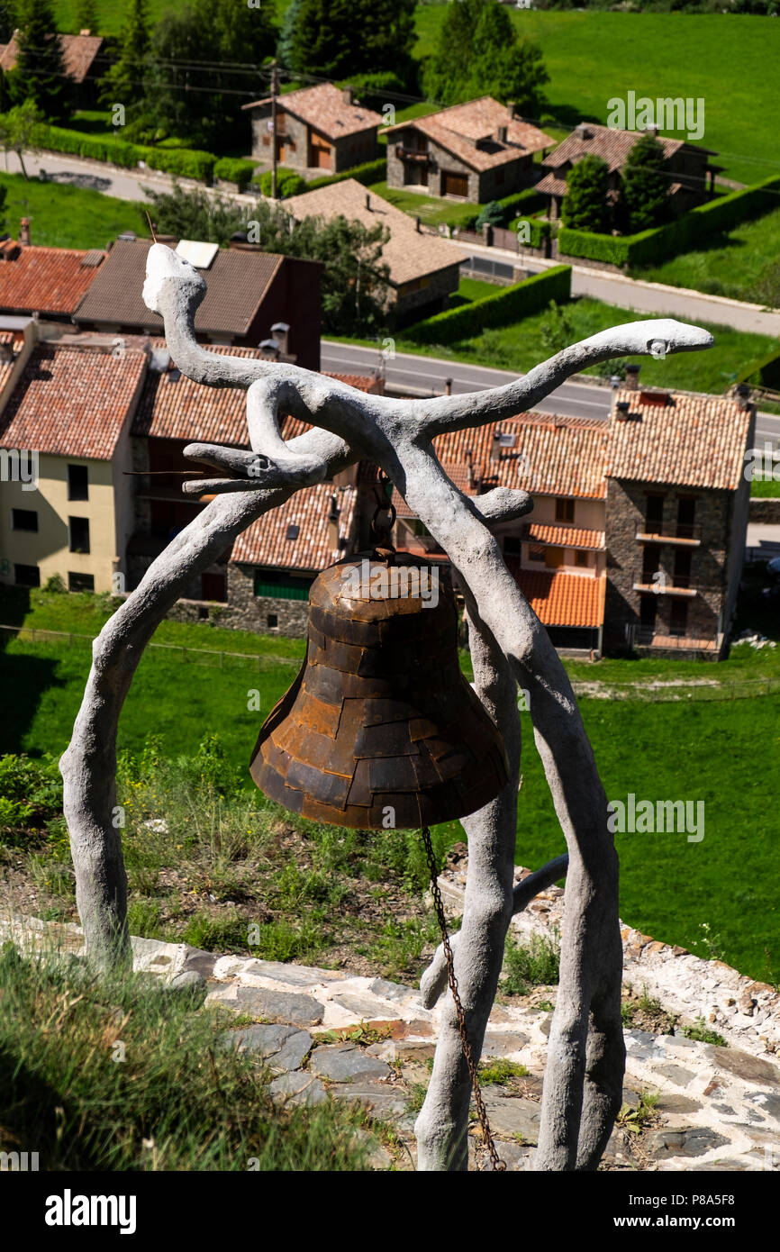 Stone and iron sculpture with snakes and a bell at the Mirador de Drac, Dragons outlook, above the village of Villalonga de Ter in the Pyrenees, Spain Stock Photo