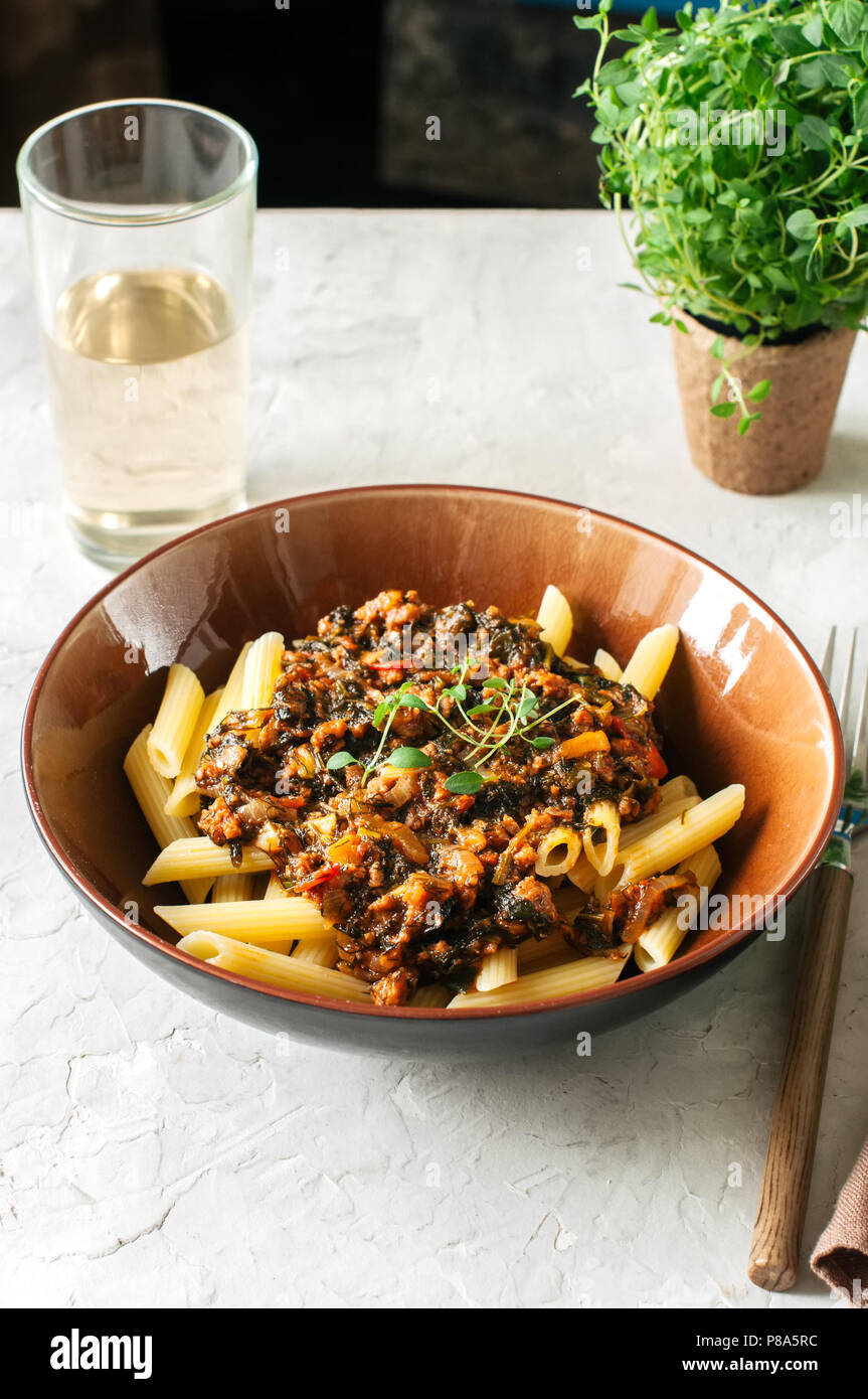 Tomato sauce ground beef pasta on a white stone background. Toned Stock