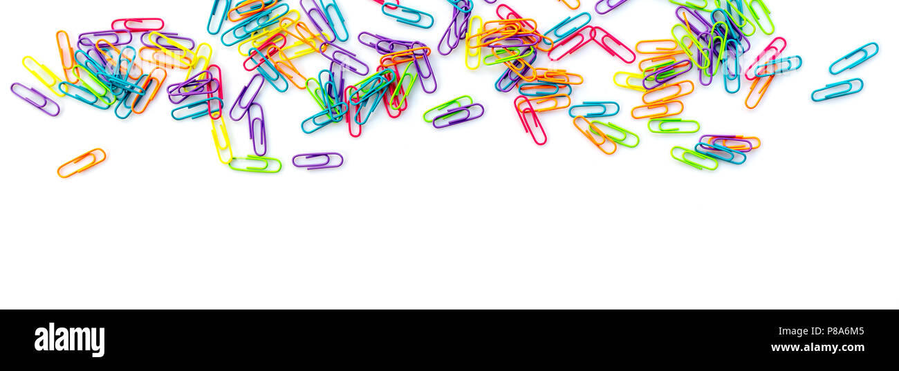 Panorama of colorful paper clips isolated on white background with copy space. Back to school web banner. Stock Photo