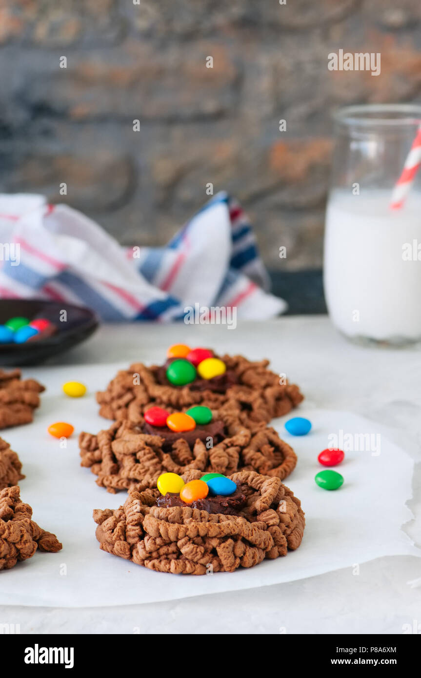 Chocolate Cookies With Colorful Smarties On A Baking Paper With Galss Of Milk Stock Photo Alamy