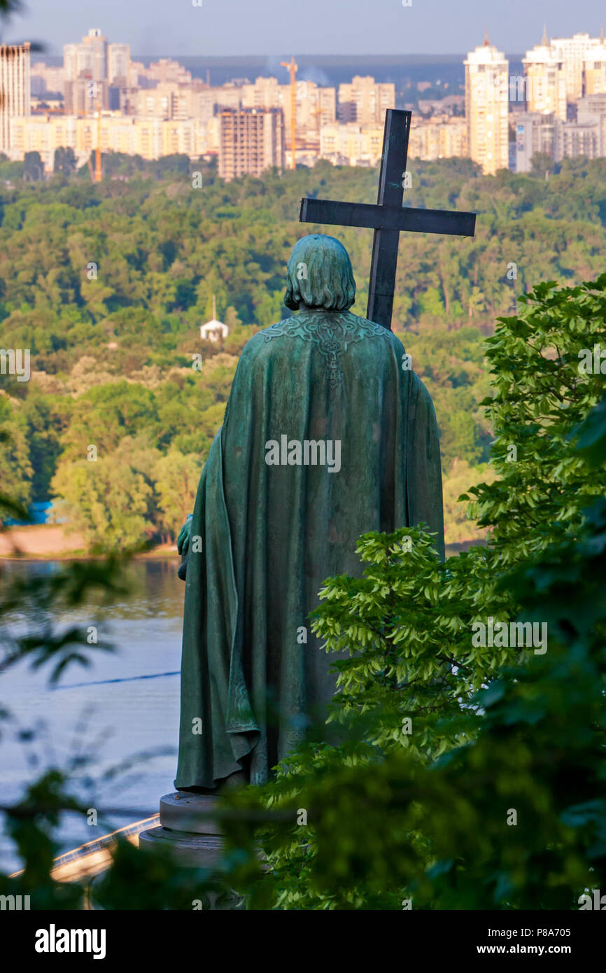 bronze monument to Volodymyr the great with a cross on the river Dnipro contemplates the city of Kiev . For your design Stock Photo