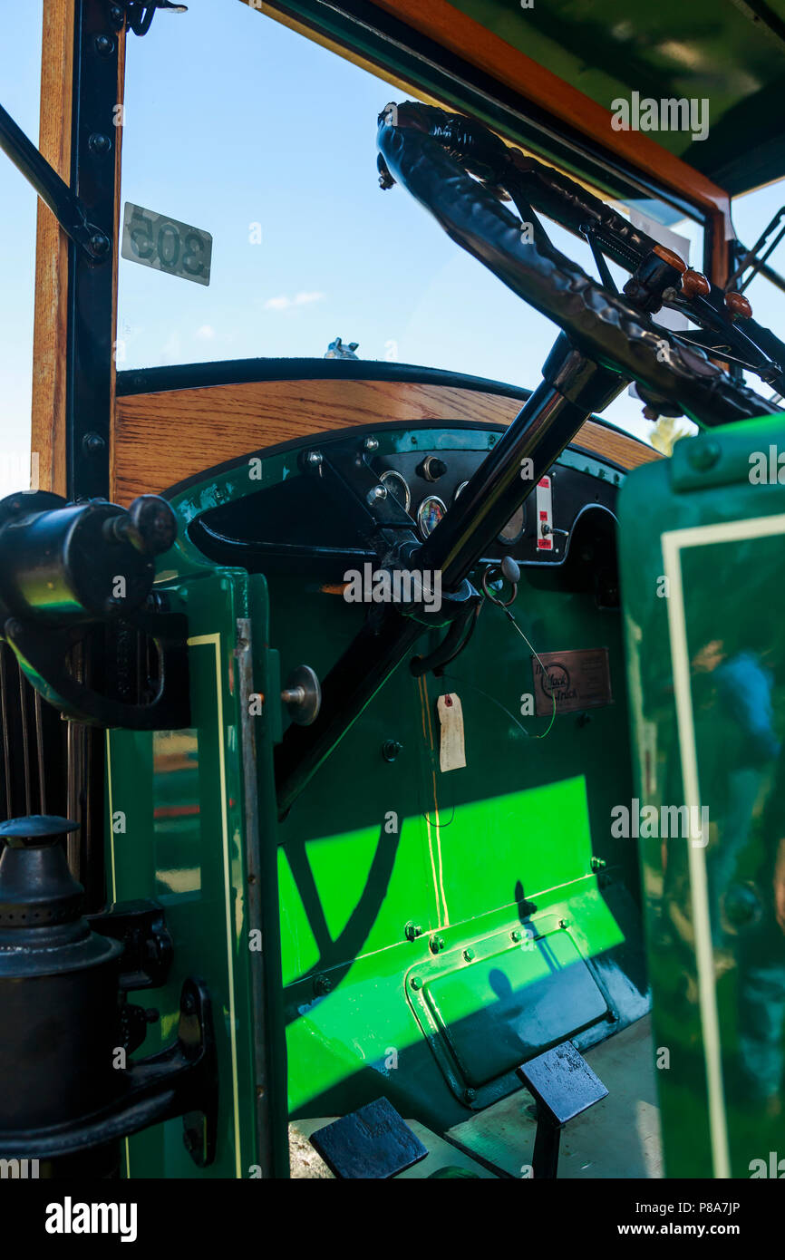 Close-up of the interior of a beautifully restored green 1920s Mack Truck (1926?) showing steering wheel, dash, pedals and gauges, Carlisle, PA 2018. Stock Photo