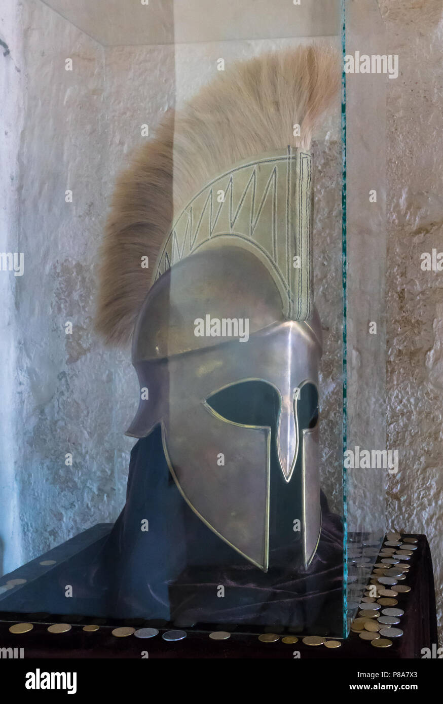 An ancient knight's helmet from metal with eye holes standing in