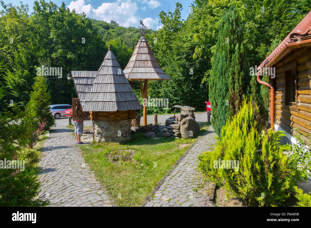 A Wooden House With A Well In The Courtyard Facing A Stone In The Middle Of The Forest The Car Came To Visitors For Your Design Stock Photo Alamy