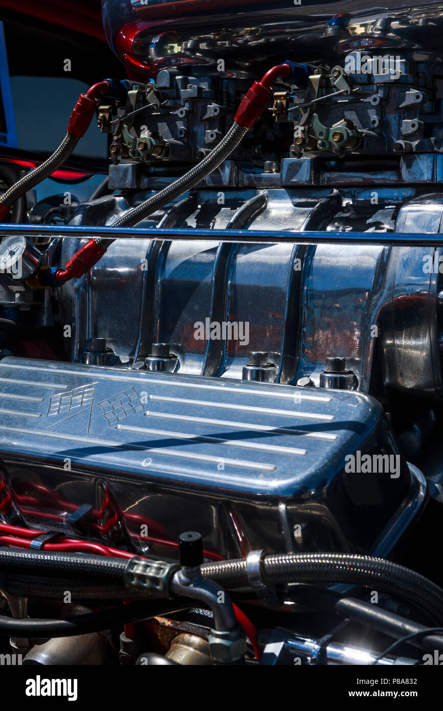 Bright close-up of supercharged Chevy hot rod engine, with lots of color and chrome and those four-barrel carbs sitting on top! Carlisle, PA  2018 Stock Photo