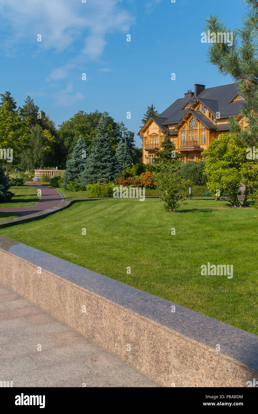 beautiful landscape from a wooden house in a park with lawn grass and