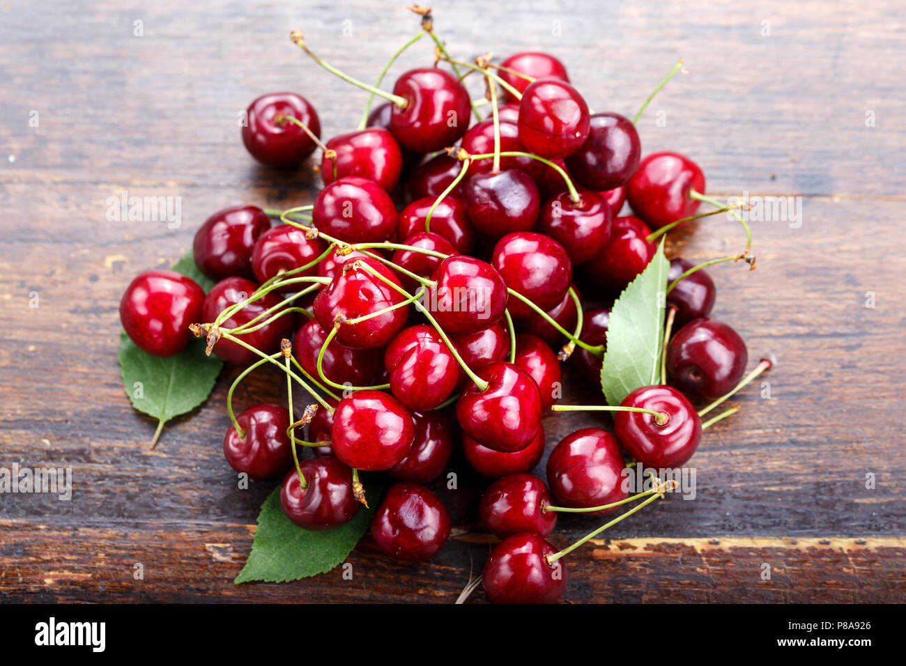 ripe cherries are scattered with a slide on the table, the harvest of ...
