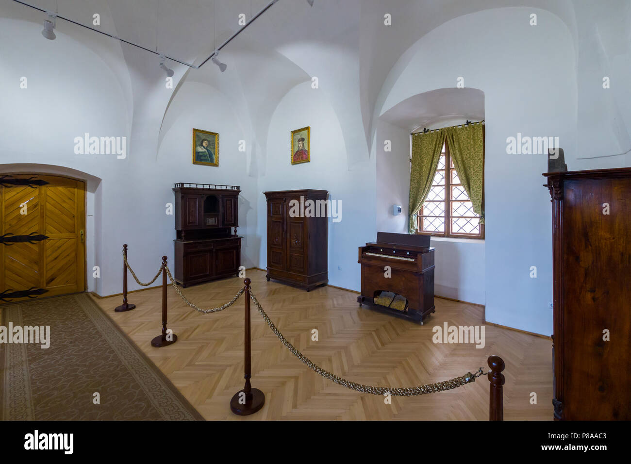 white museum exhibition hall with rarity wooden furniture, portraits ...