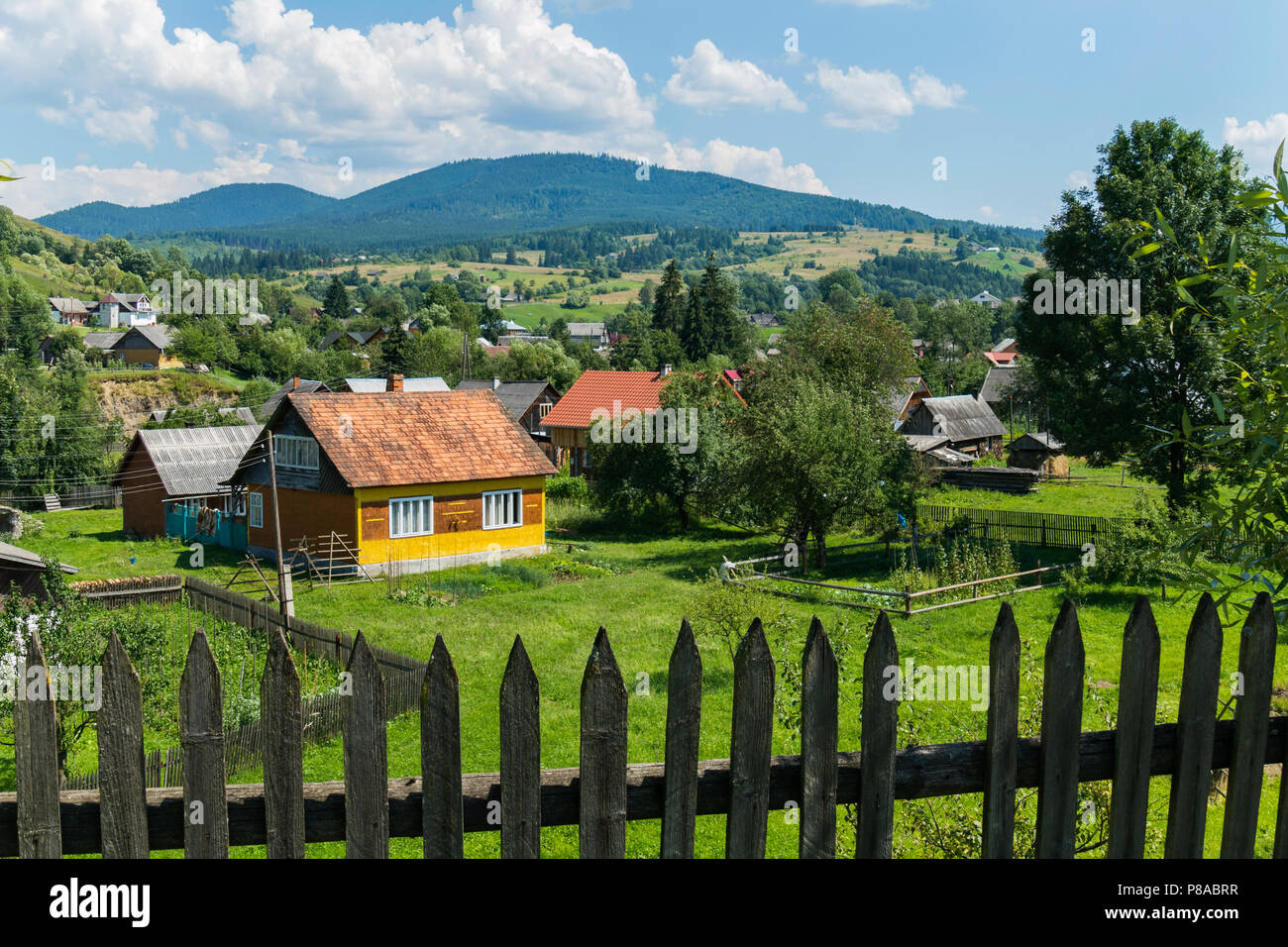 Old wooden fence on the background of a rural mountain village with ...