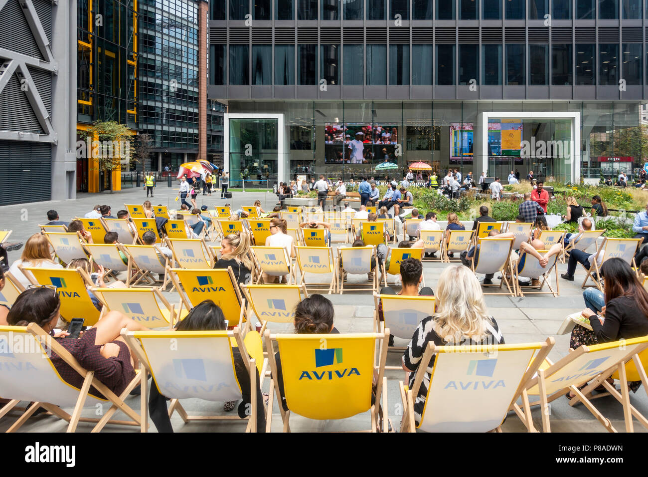 People, mainly local workers, enjoying a relaxing summer lunchtime in St Helen's Piazza, Leadenhall Street, City of London, England, UK Stock Photo