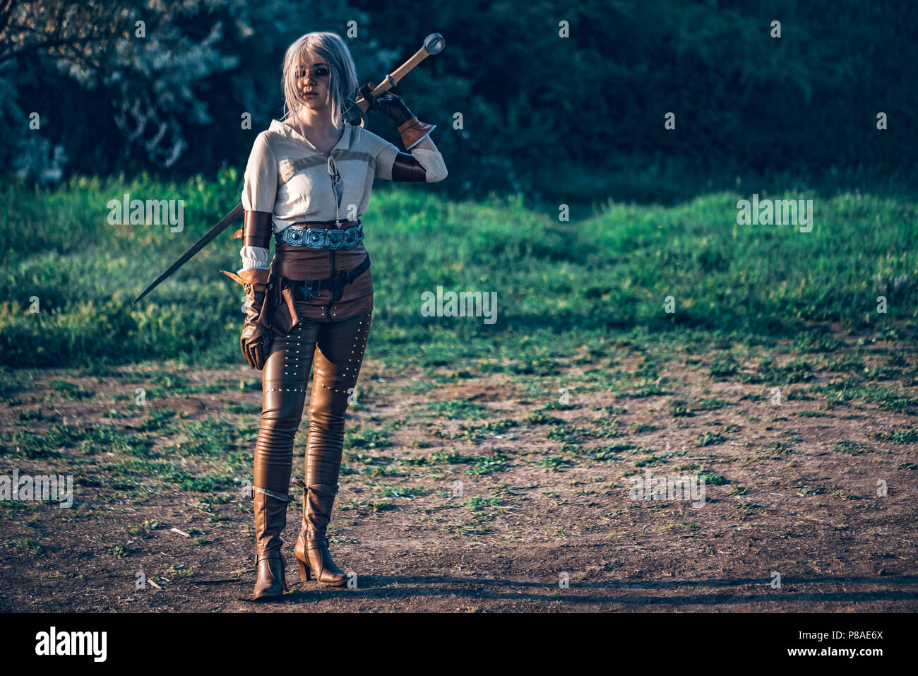 Fantasy cosplay beautiful Witcher girl with sword Stock Photo