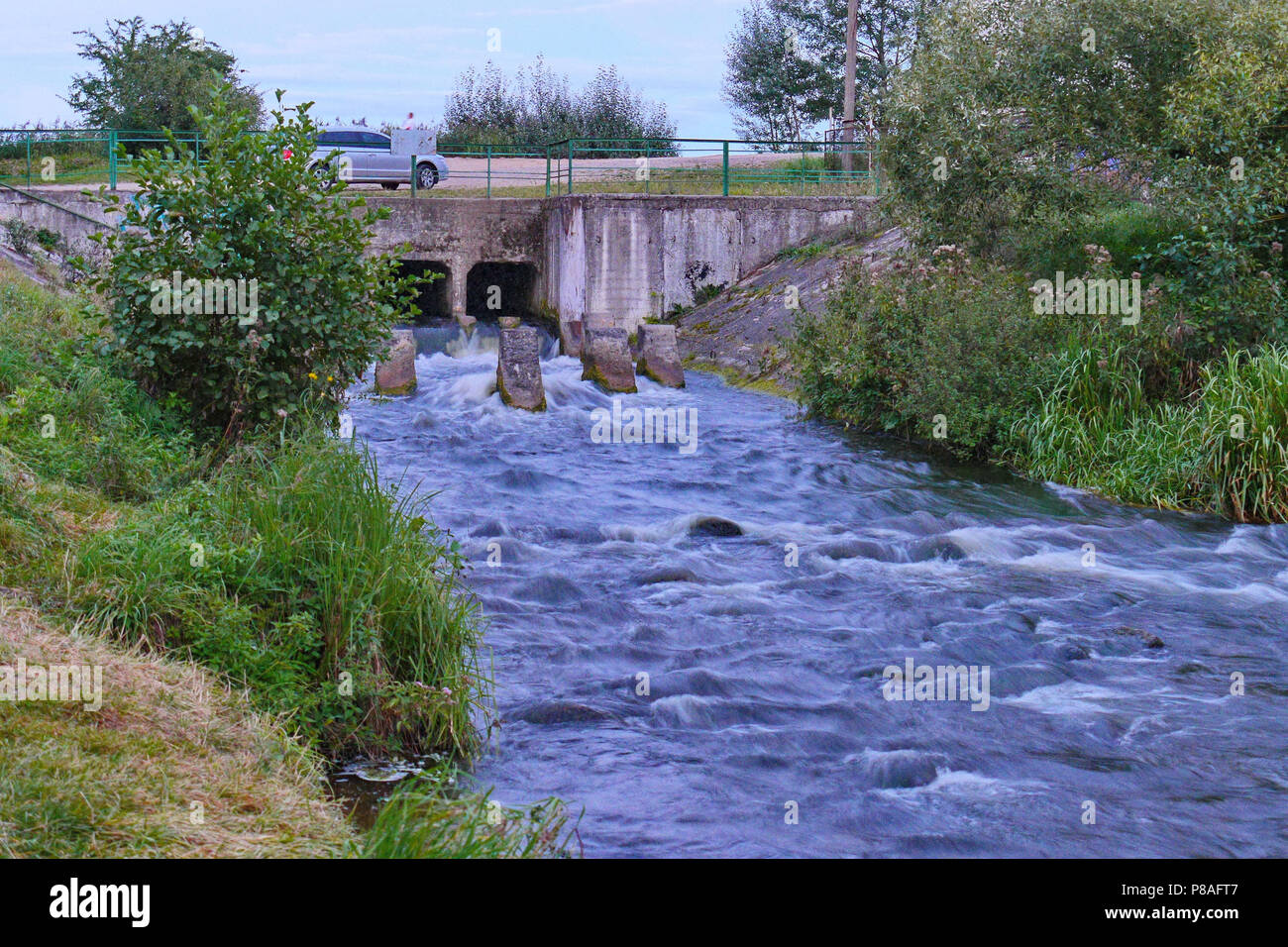 car bridge over a small, stormy river with foggy water on rapids . For your  design Stock Photo - Alamy