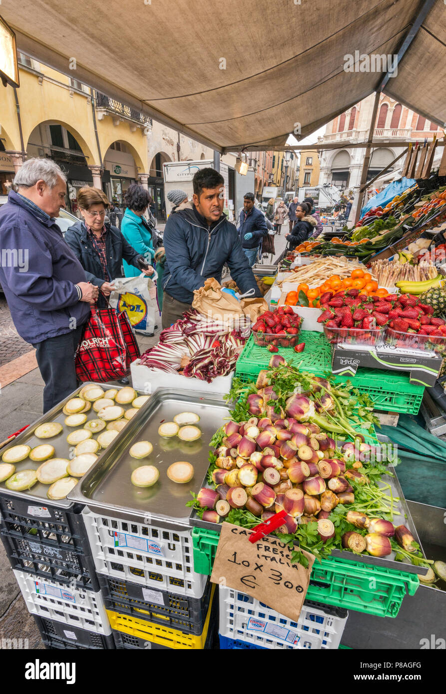 Artichoke hearts and baked slices at greengrocer stall, Piazza delle Erbe in Padua, Veneto, Italy Stock Photo