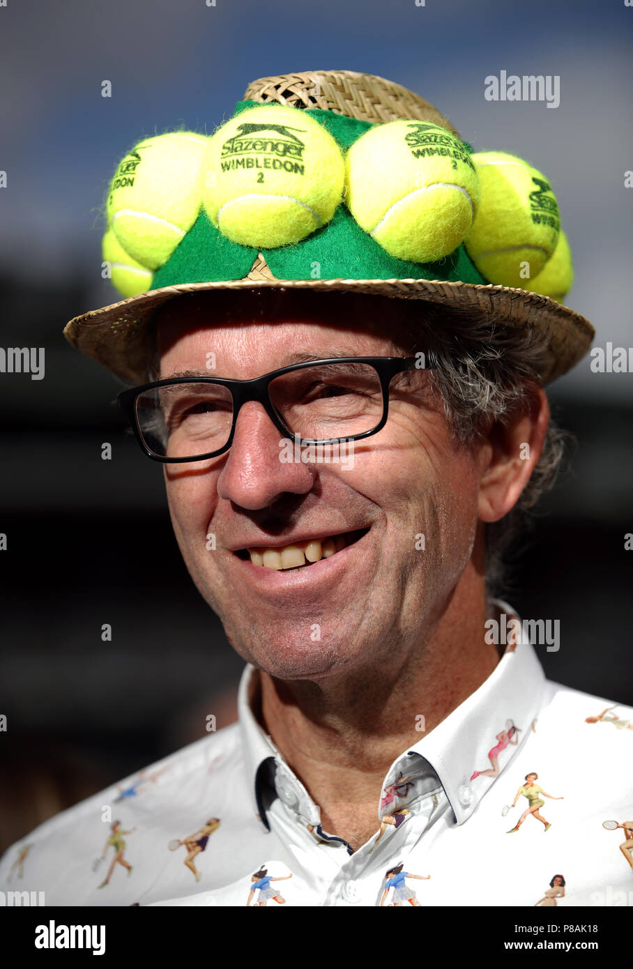 A spectator wearing a tennis ball themed hat on day eight of the Wimbledon Championships at the All England Lawn Tennis and Croquet Club, Wimbledon. Stock Photo