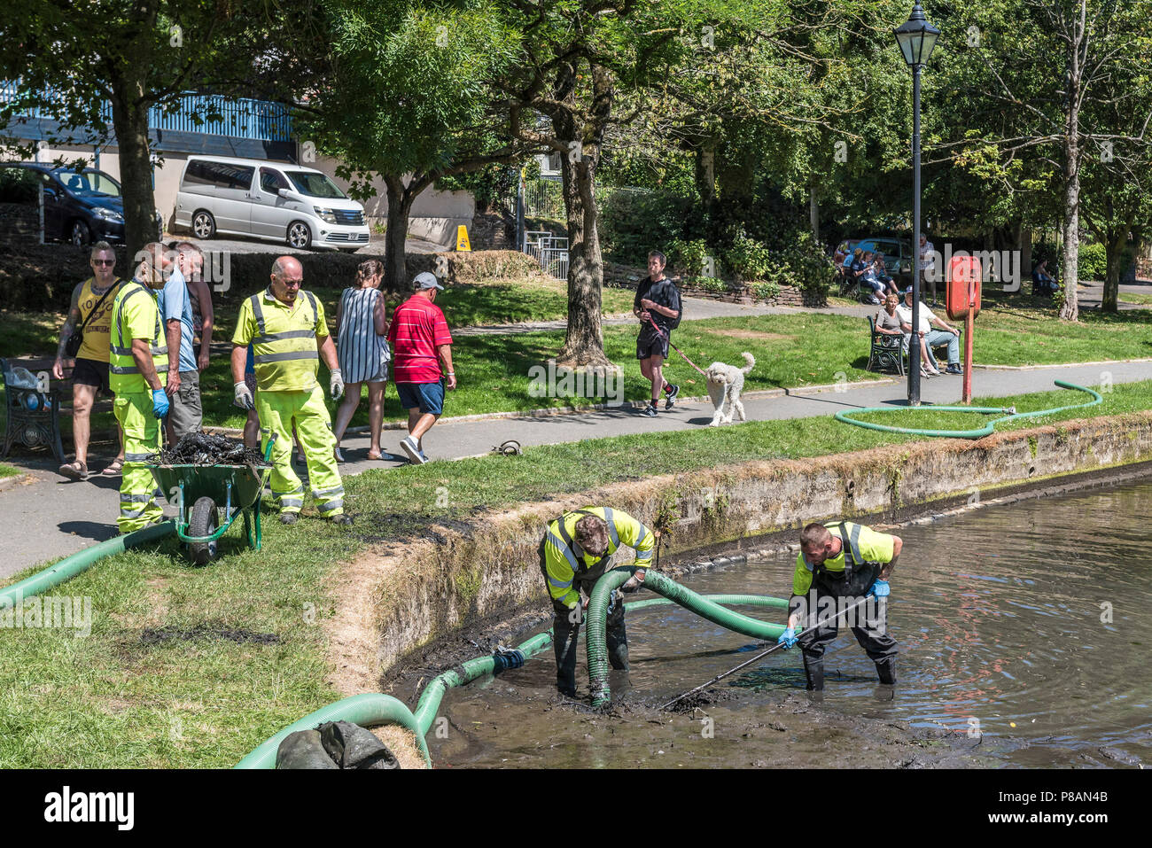 Workers using a suction pump to remove mud and silt in a lake. Stock Photo