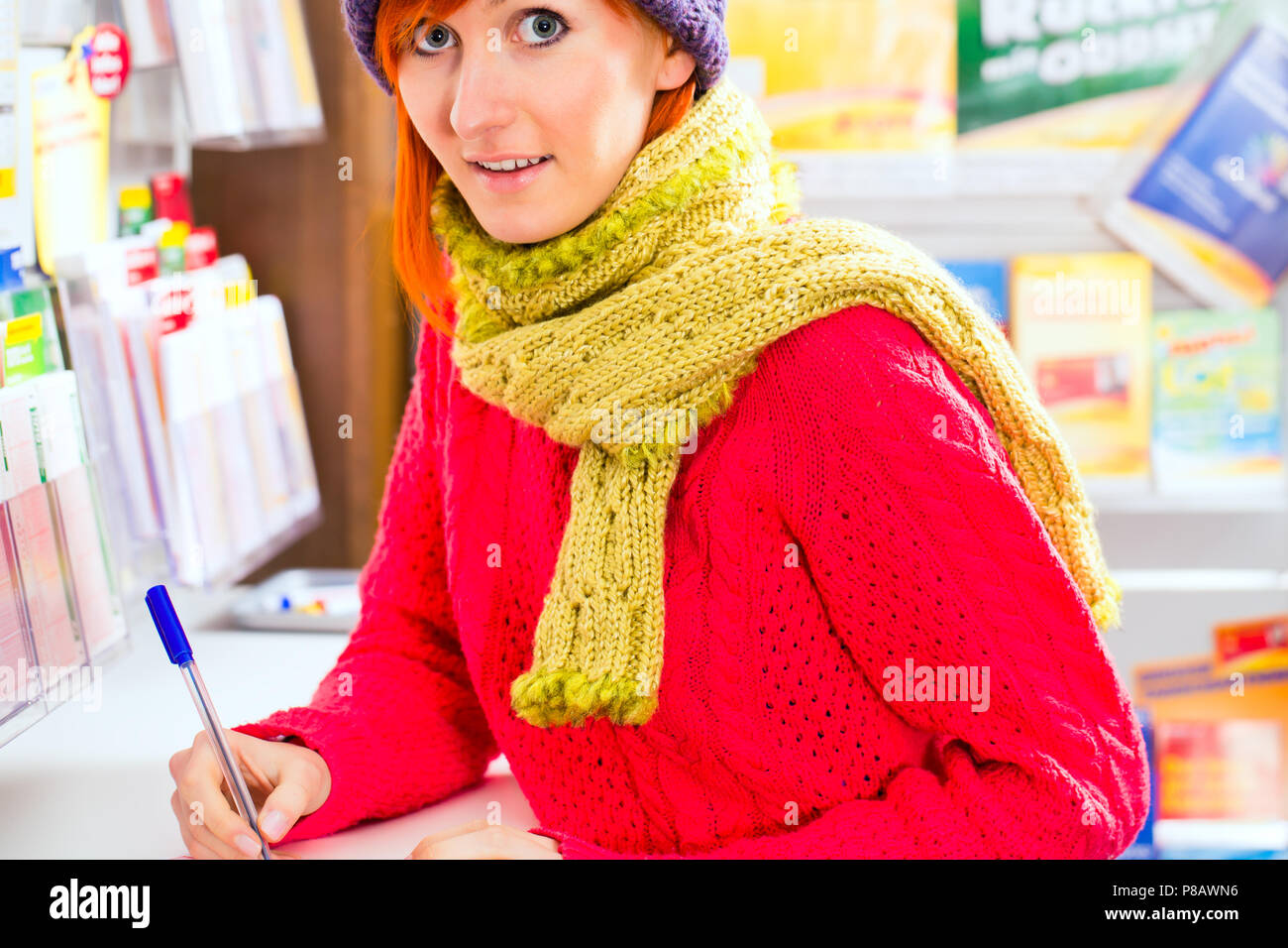 Young woman in Lotto shop playing ticket Stock Photo