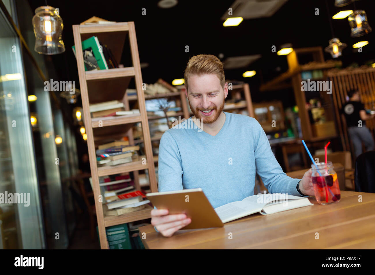 Young man using digital tablet in coffee shop Stock Photo