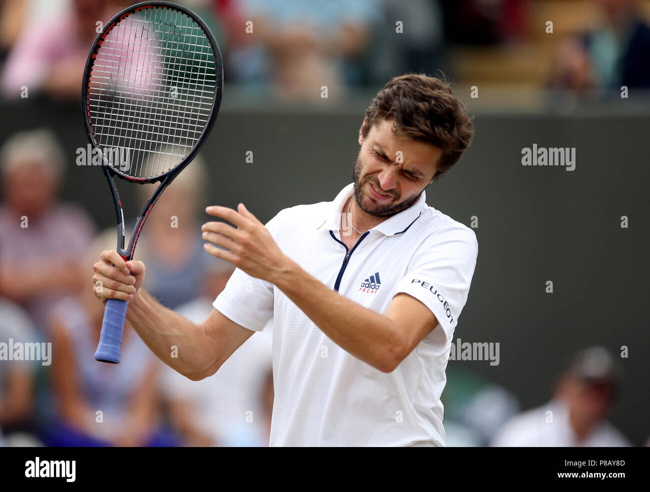 Gilles Simon reacts on day eight of the Wimbledon Championships at the All England Lawn Tennis and Croquet Club, Wimbledon. Stock Photo