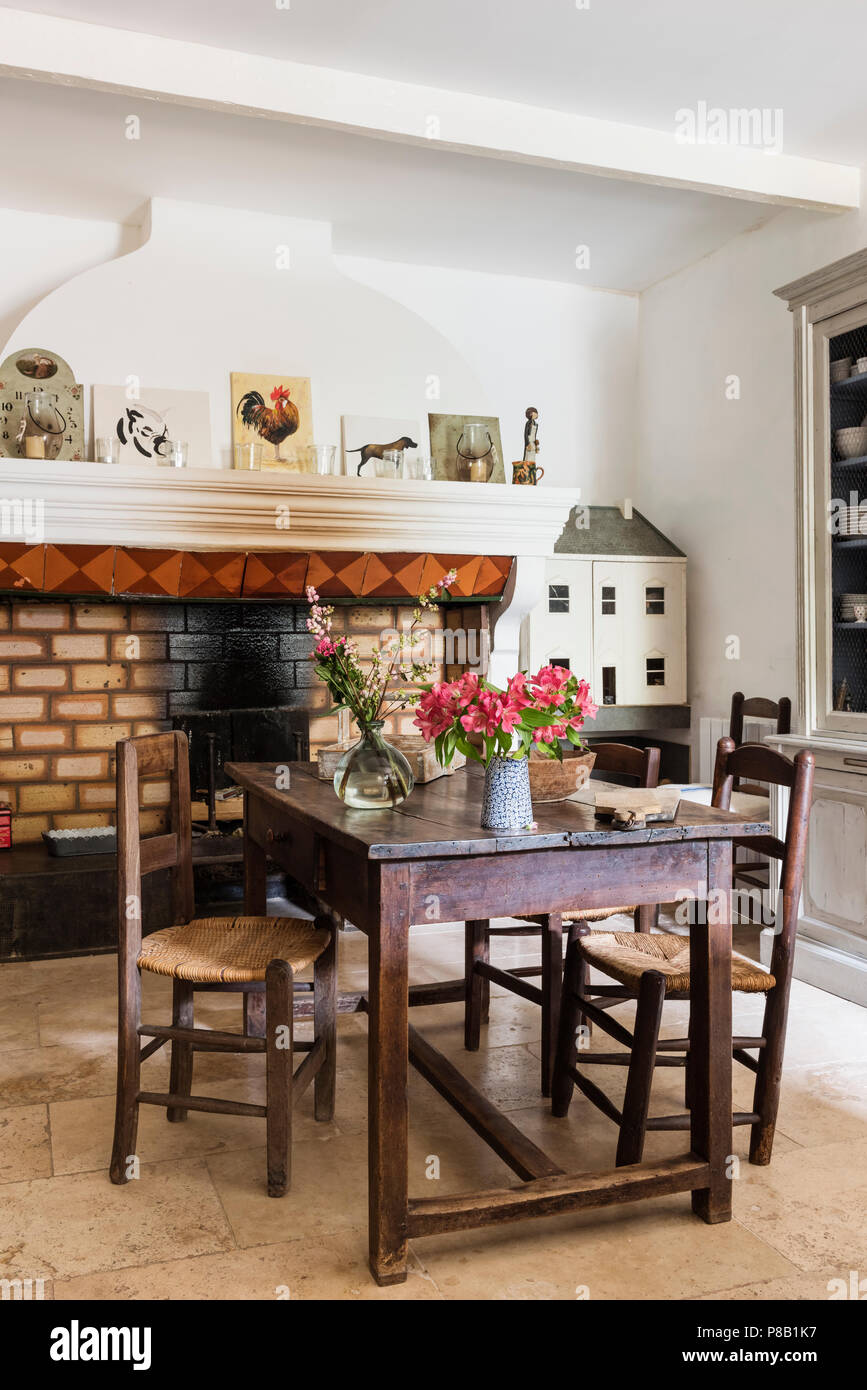 19th century table and unmatched chairs. Stock Photo