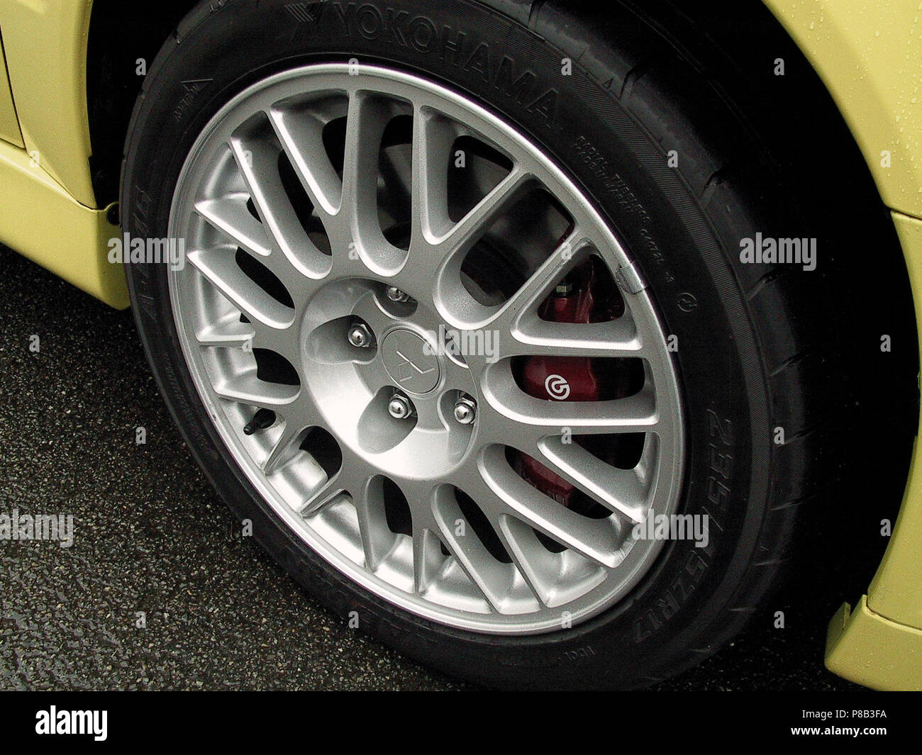 Mitsubishi Lancer Evolution 7 vii EVO - 2002 model in lightening yellow  colour - showing close up of alloy wheels and brakes Stock Photo - Alamy