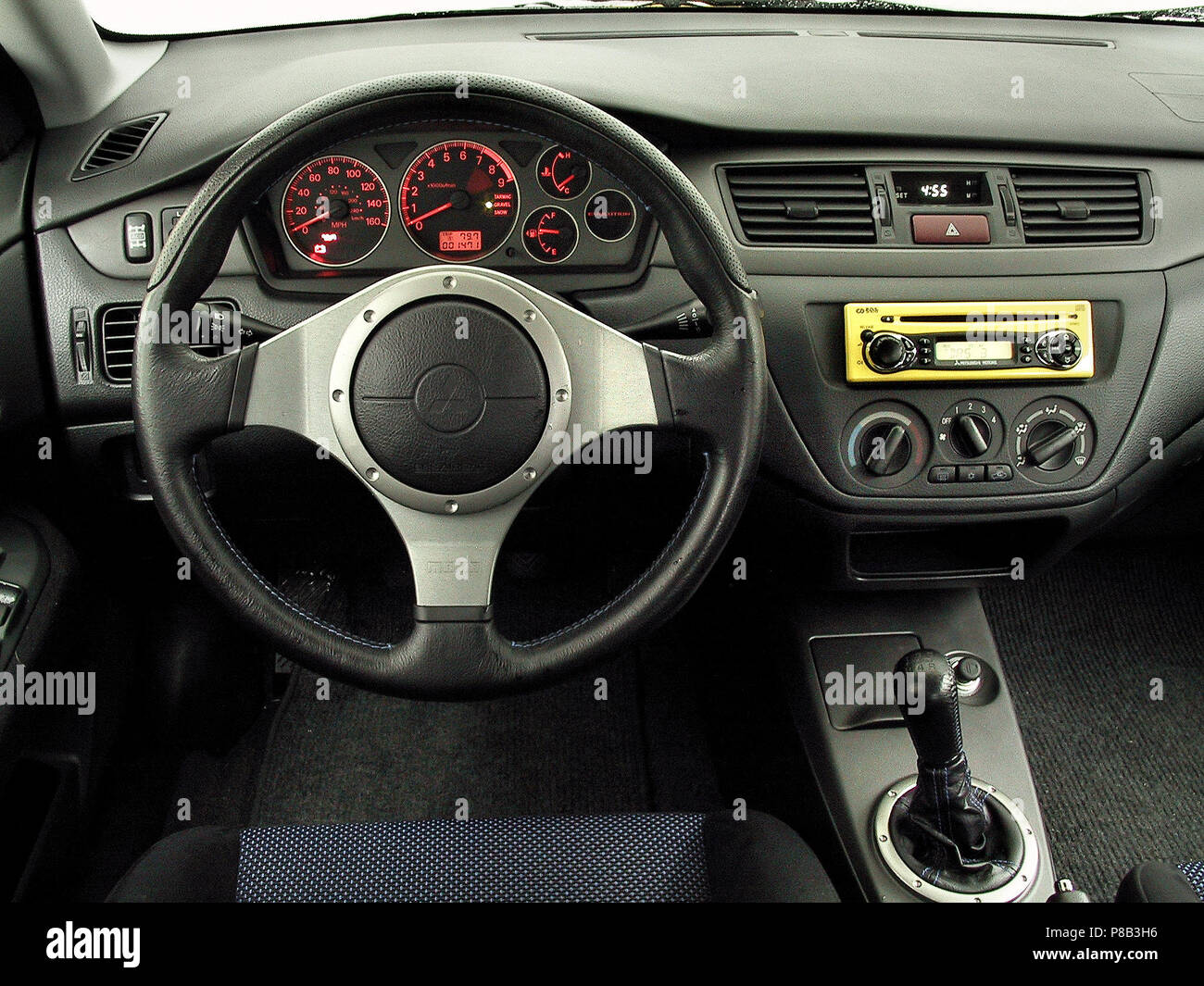 https://c8.alamy.com/comp/P8B3H6/mitsubishi-lancer-evolution-7-vii-evo-2002-model-in-lightening-yellow-colour-showing-drivers-seat-and-steering-wheel-and-dashboard-controls-P8B3H6.jpg