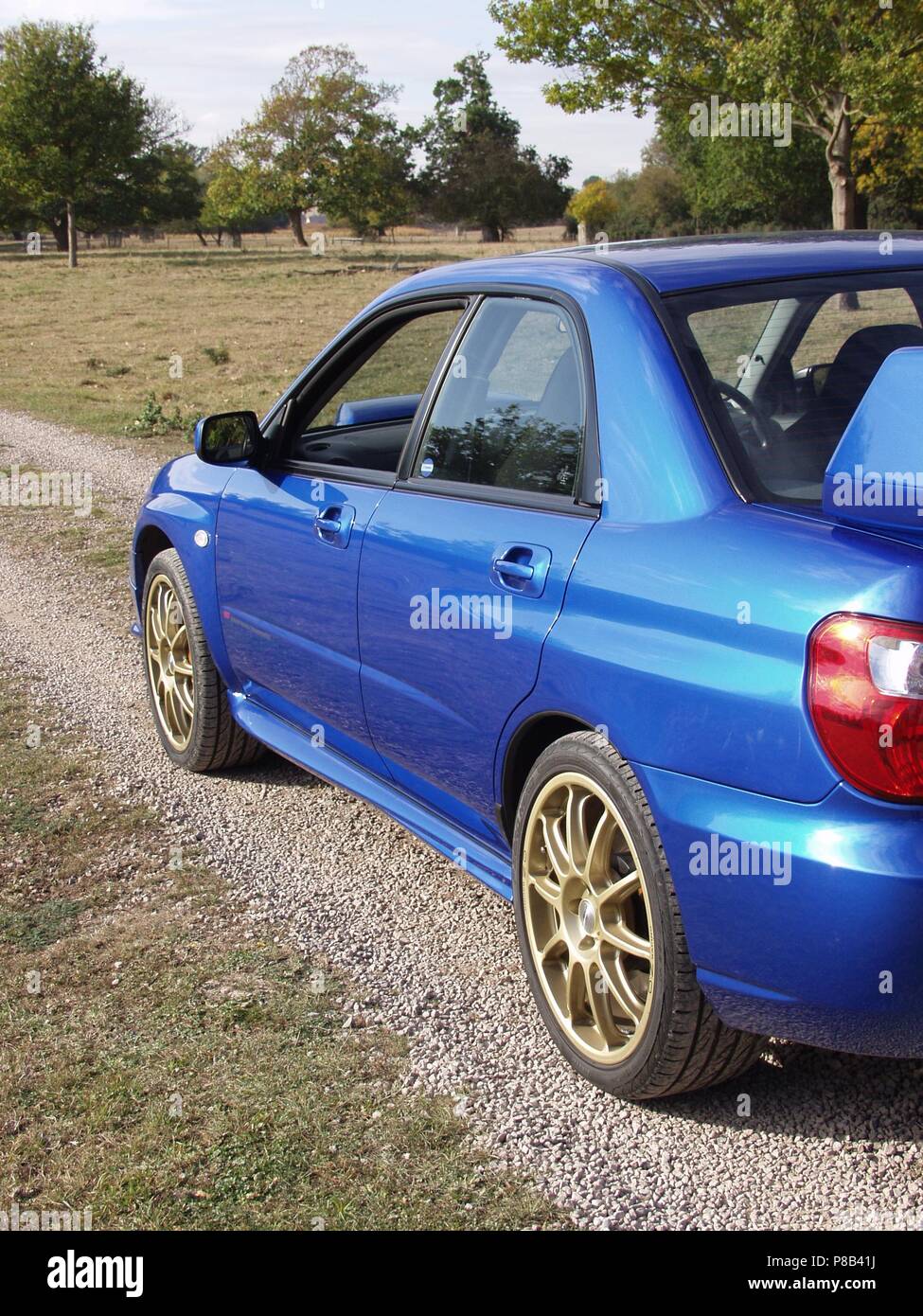 Subaru Impreza WRX STI in WR blue pearl colour with alloy wheels - showing rear and side view Stock Photo