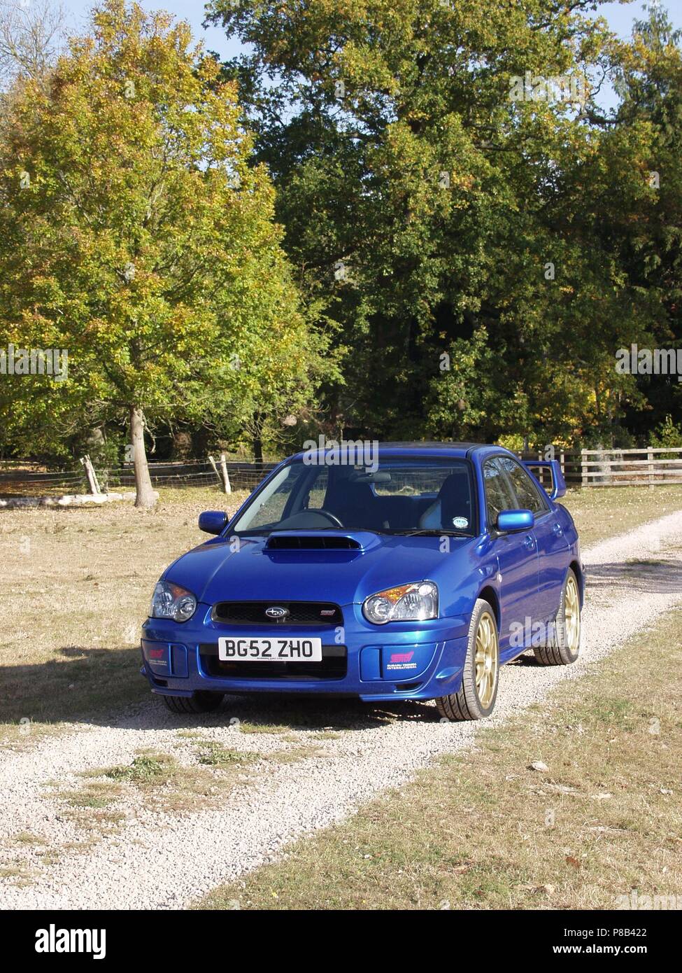 Subaru Impreza WRX STI in WR blue pearl colour with alloy wheels - showing front and side view in countryside Stock Photo