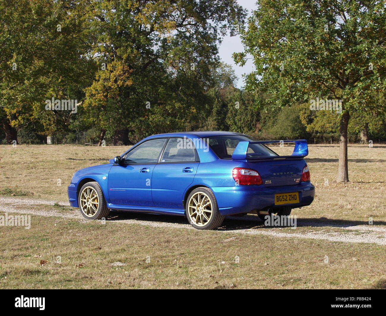 Subaru Impreza Wrx Sti In Wr Blue Pearl Colour With Alloy Wheels - Showing Side And Rear View Stock Photo - Alamy