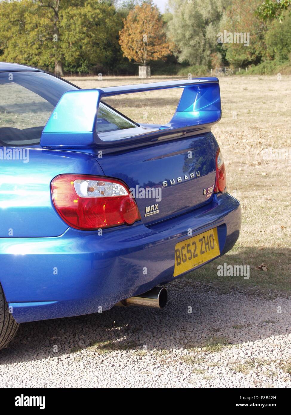 Subaru Impreza WRX STI in WR blue pearl colour with alloy wheels - showing close up of rear spoiler and exhaust Stock Photo