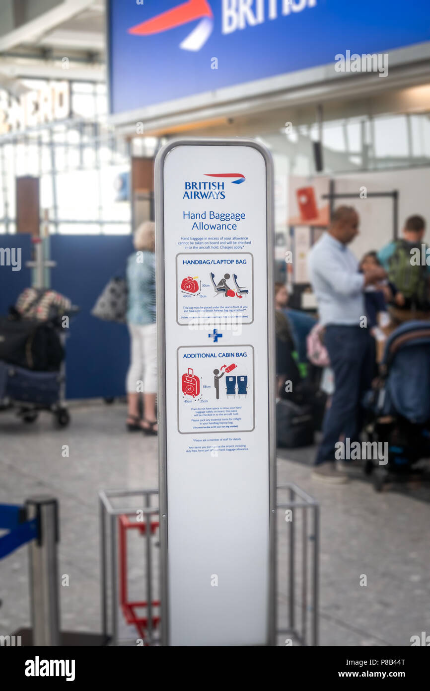 British Airways hand baggage allowance information board at Heathrow Airport Stock Photo