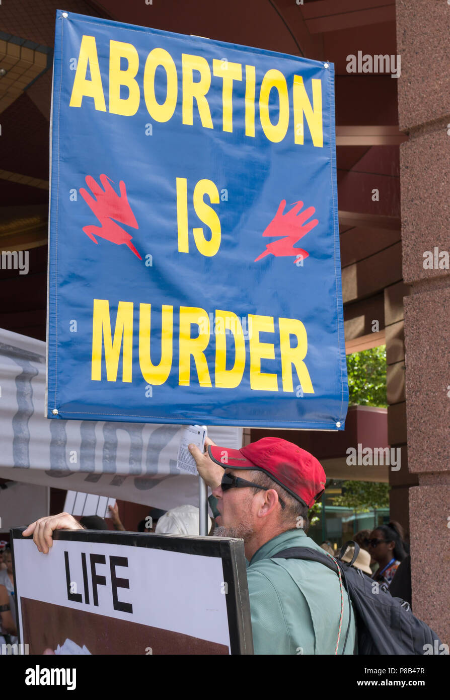 MINNEAPOLIS, MN/USA - JUNE 30, 2018: An unidentified individual holding sign in a public anti-abortion demonstration. Stock Photo