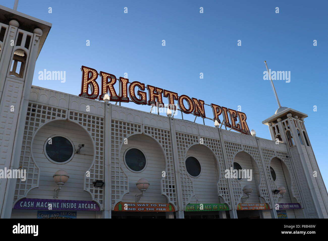 Brighton Pier sign illuminated on a sunny day against a blue sky Stock
