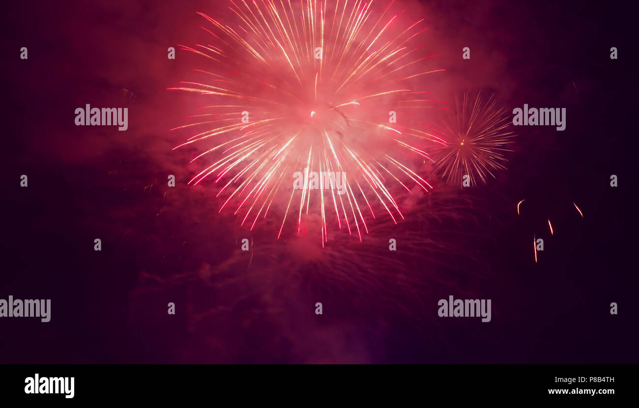 red fireworks display in night sky to celebrate event Stock Photo